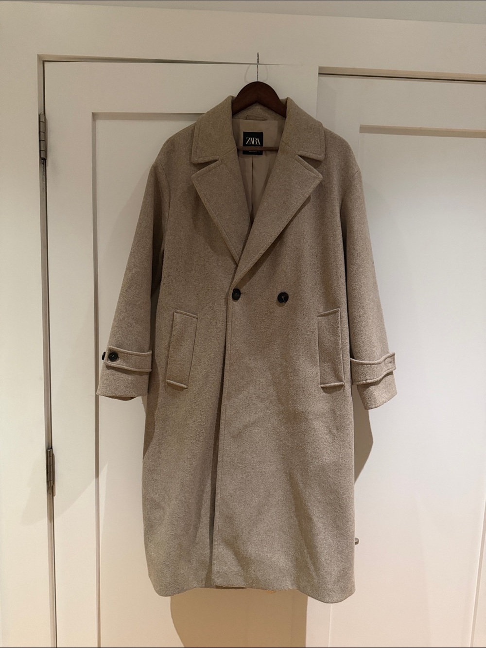 Woman’s long, oversized, double-breasted wool-blend coat.